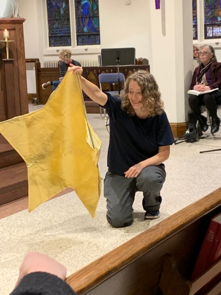 Co-Director of Christmas Pageant holding gold star costume