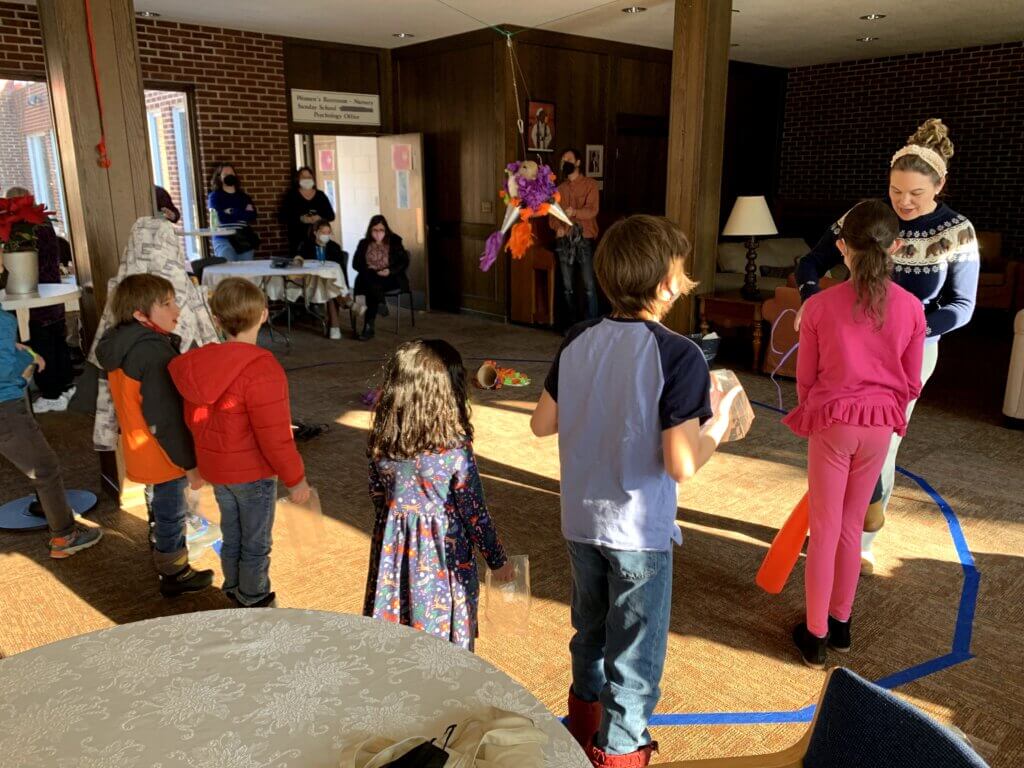 Children breaking piñata during Epiphany party in St Mary's Room