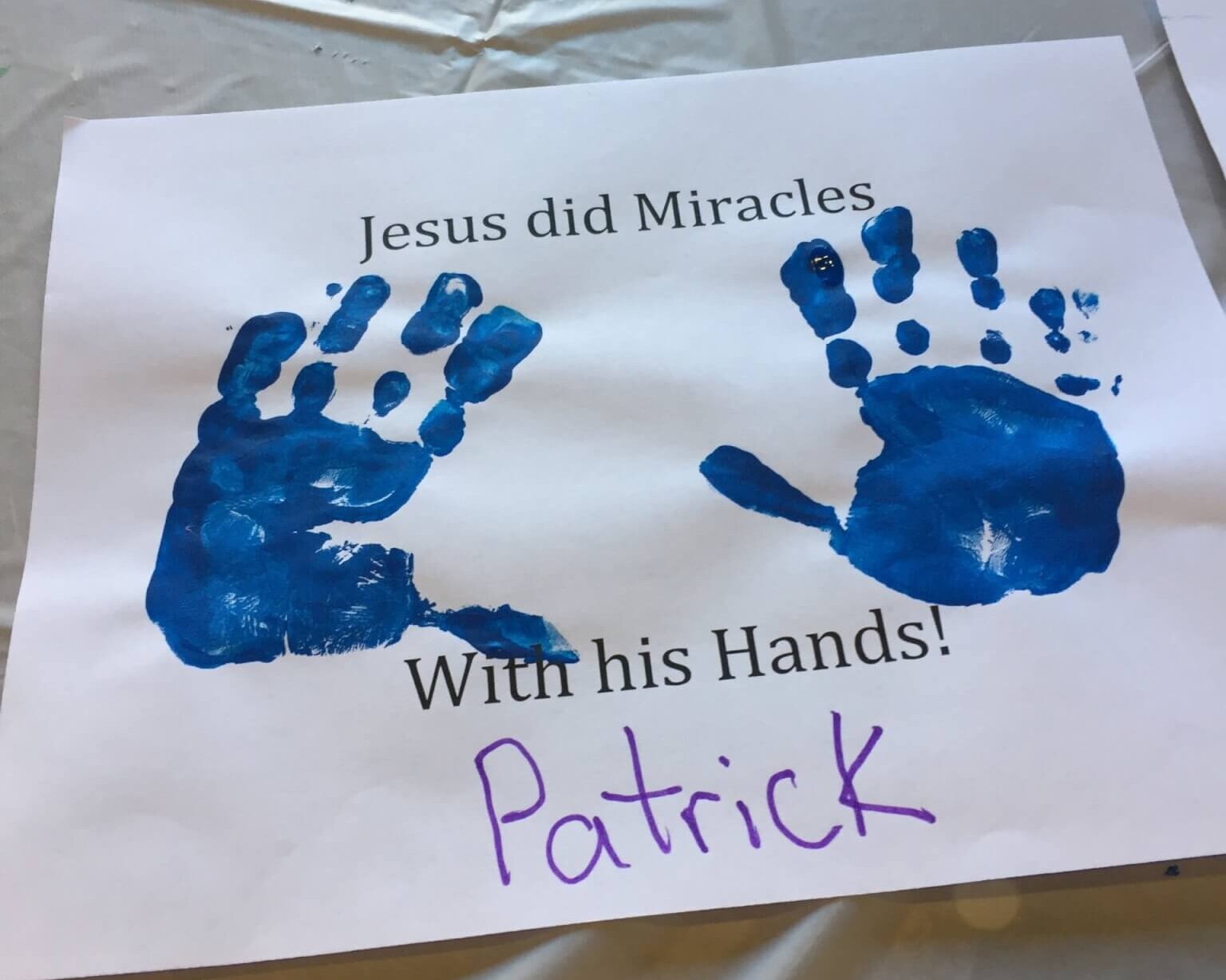 Jesus did Miracles with his Hands; blue handprints on sign