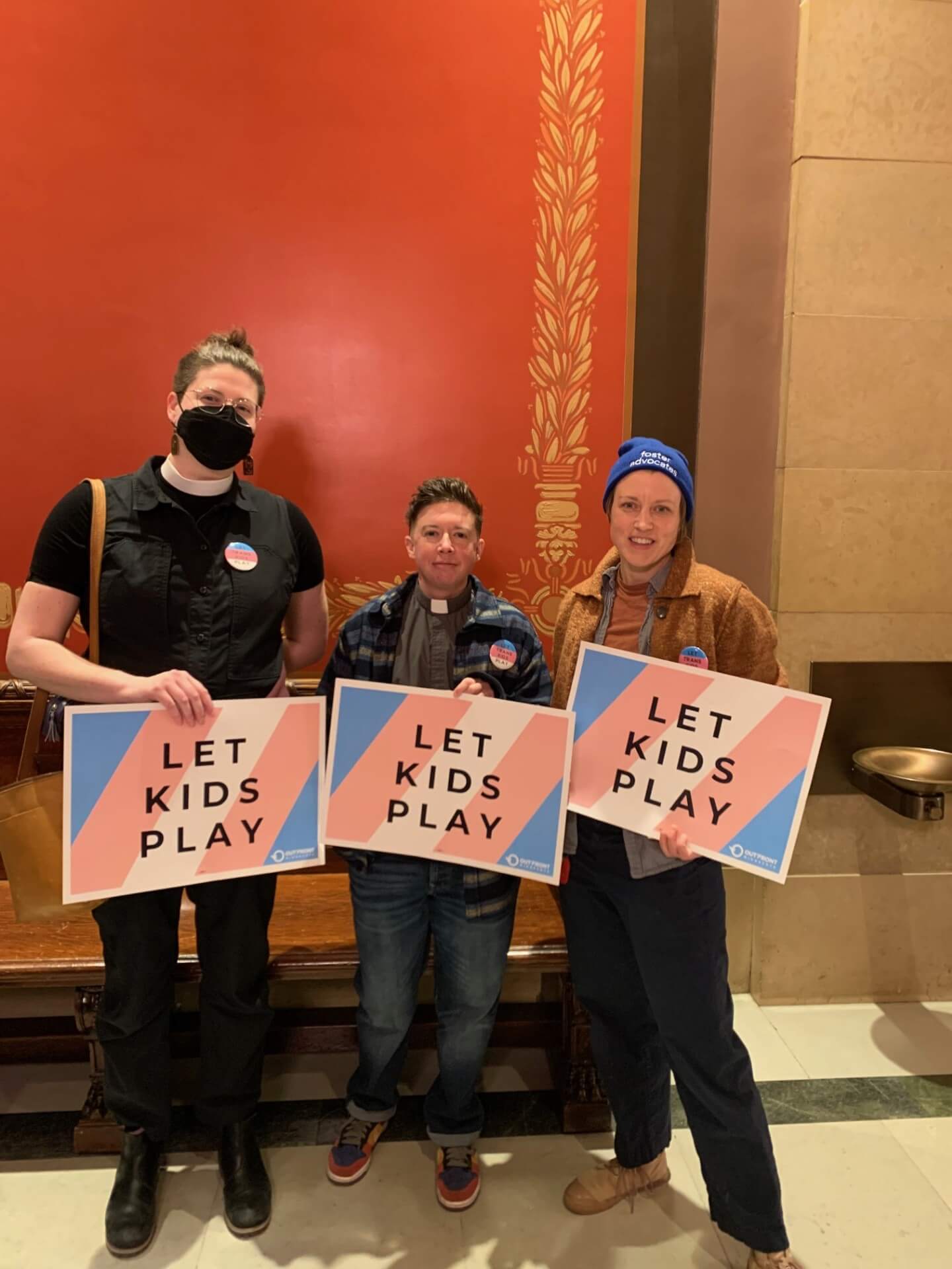 Reverend Lindsey with Friends holding signs that say Let Kids Play