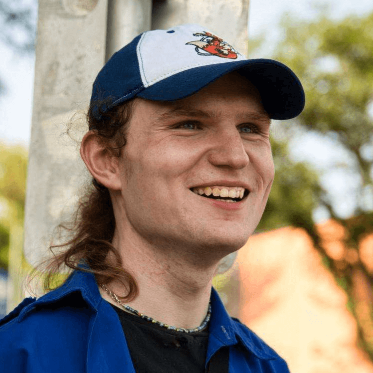 Photo of Grace Norton, the administrator at Saint Mary's, smiling and wearing a blue hat